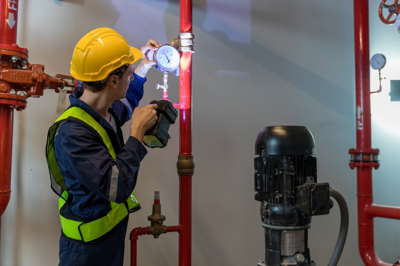 Engineer or technician work checking Fire suppression system and fire equipment.