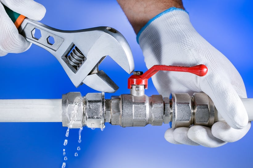 Hands plumber at work in a bathroom, plumbing repair service.