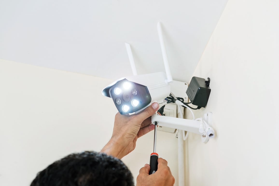 Technician Installing a Wireless CCTV Camera Up Close