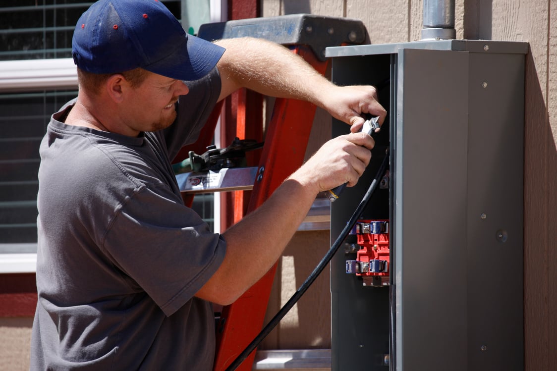 Electrician Working on Electrical Service Panel